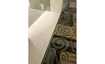 Interior construction within the new Terminal D at the new BNA Vision addition of the Nashville International Airport shows where the expansion joint covers for the floor, wall and ceiling will be installed.