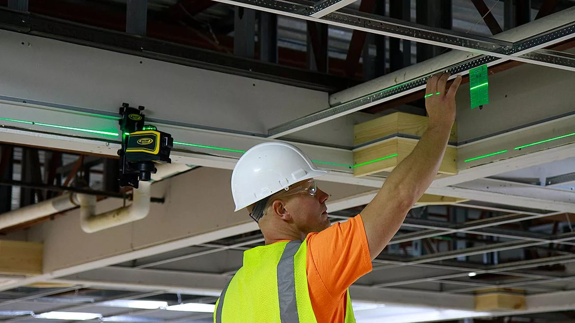 A worker examines a LASER setup