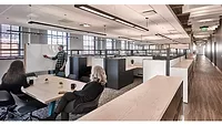 Rockfon WHEDA Offices Picture 1 Man pointing at whiteboard with two women sitting down watching him