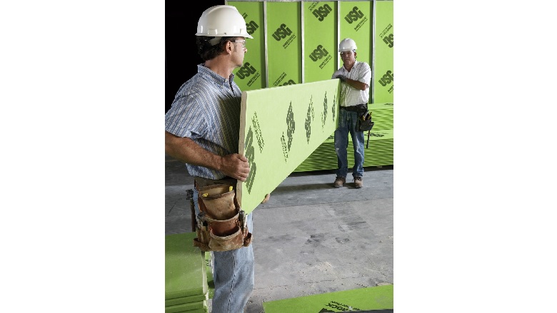USG Corp. Contractors Carrying Drywall