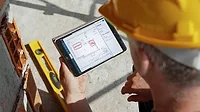 Axia Public Relations eSUB Construction Software Man Looking at eSUB Software on iPad