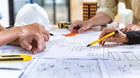 People working on a blueprint