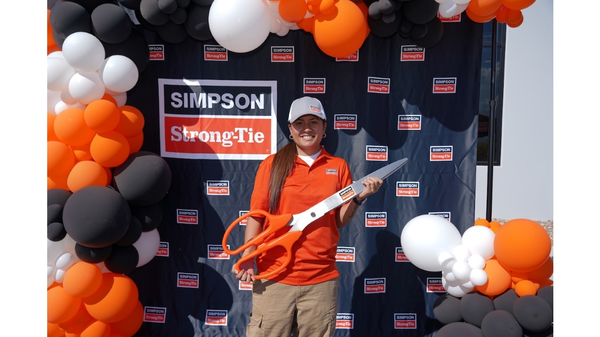 Simpson Strong-Tie Employee Holding Ribbon-Cutting Scissors