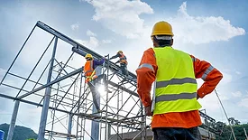 Construction Workers Climbing Scaffolding