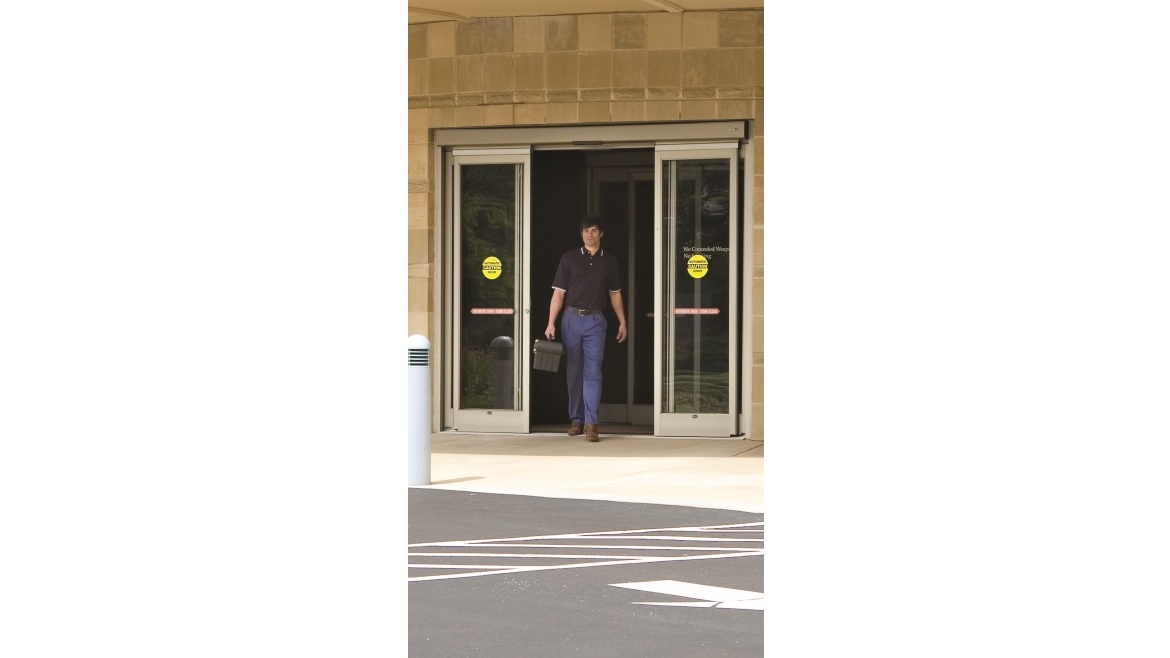 Technician Walking Through Automatic Doors