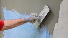 Stucco being applied to a wall