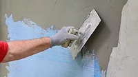 A Stucco Application Stucco being applied to a wall