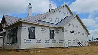 A house with Tyvek weatherproofing and no siding