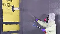 Installing an All Weather Barrier A man applying spray foam