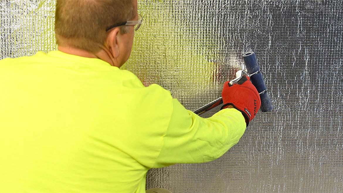An man installing a weather barrier