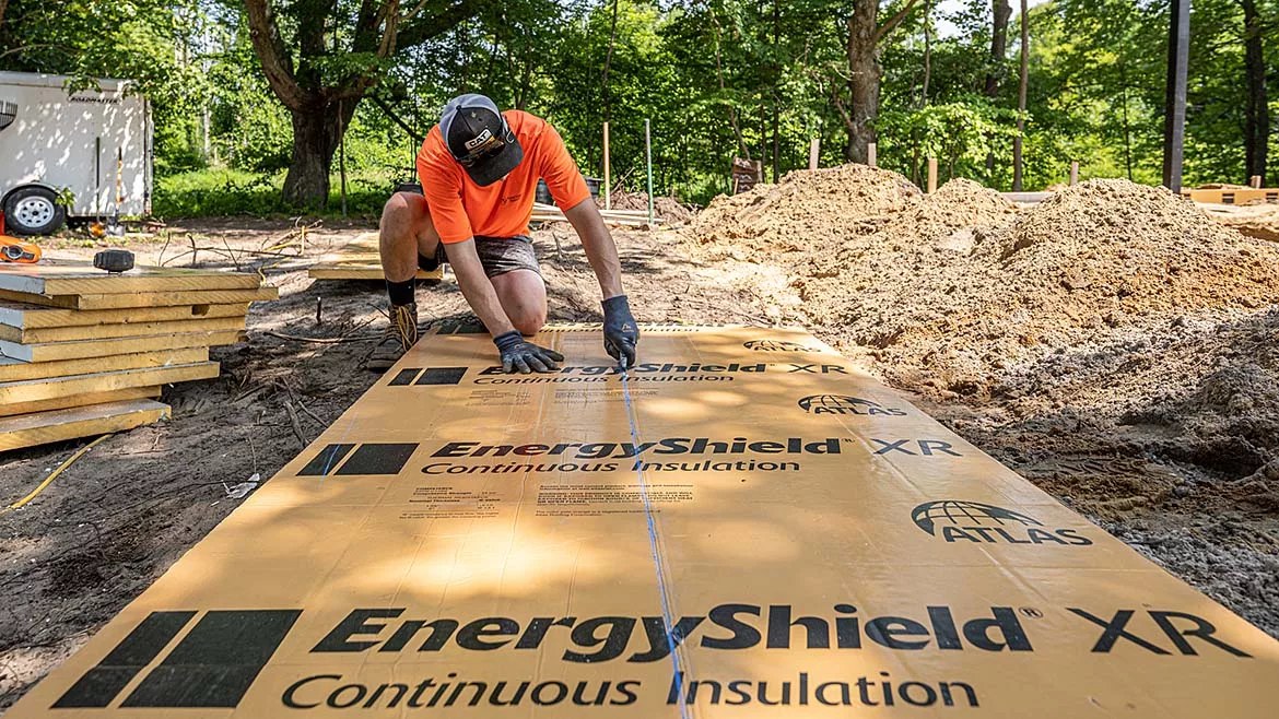A man installing an insulation panel
