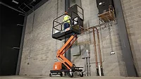 A worker using an aerial lift
