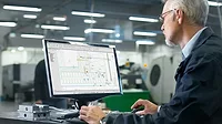 CAD software A man using CAD software on a desktop computer