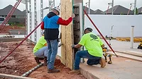 Retail Space 3 workers placing a wall at a construction site