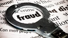 Stock art of a handcuff framing the word 'fraud'