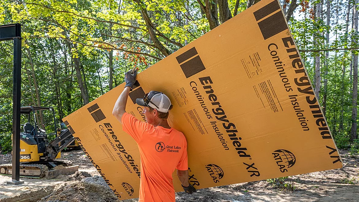 A man holding an insulation panel