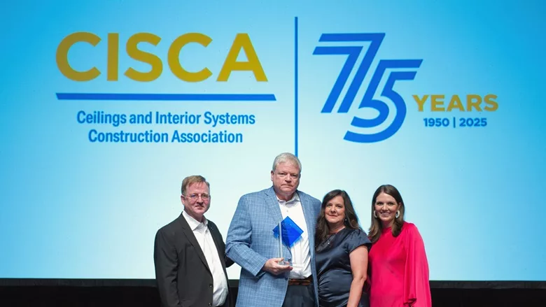 Ron Rice holding a CISCA Award 
