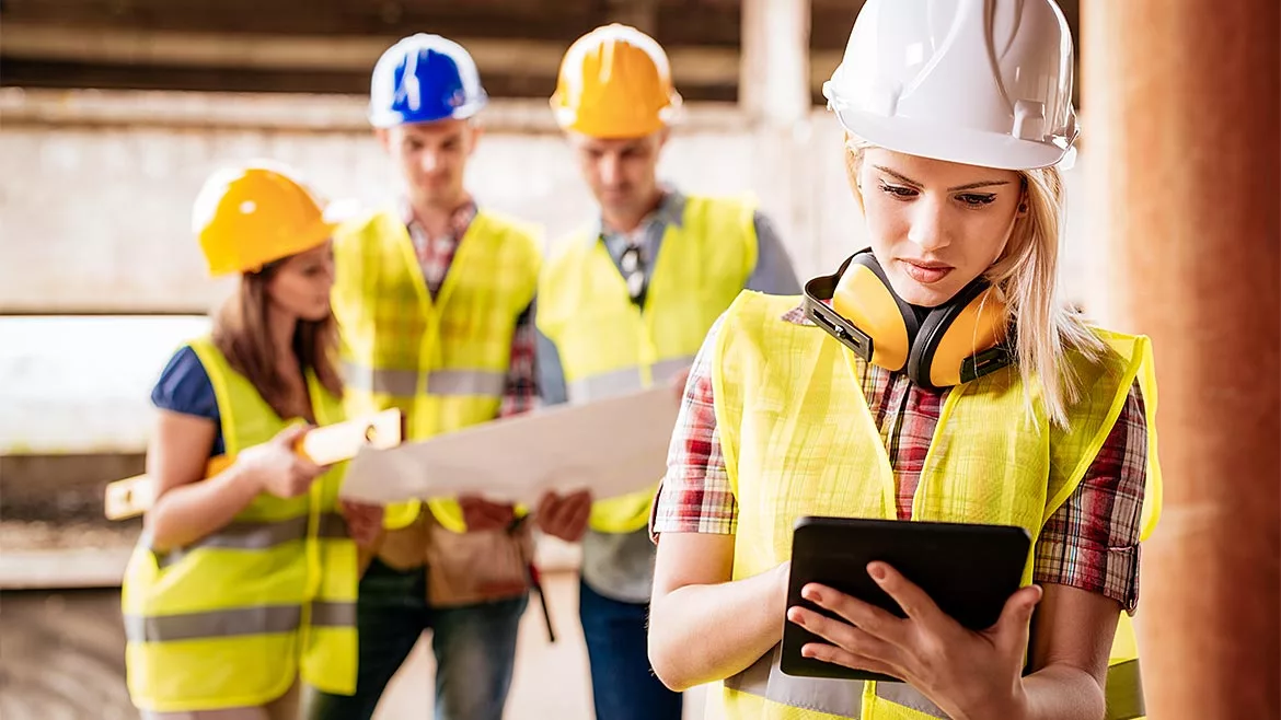 YOung construction workers using technology