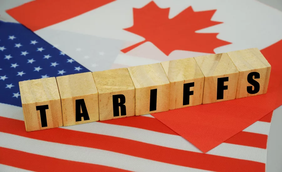 the word tariffs with a canadian and american flag