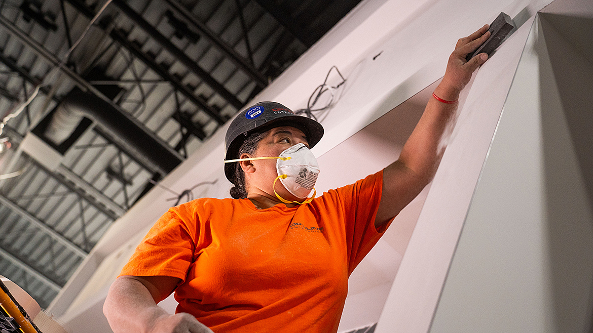 Contractors in orange shirts