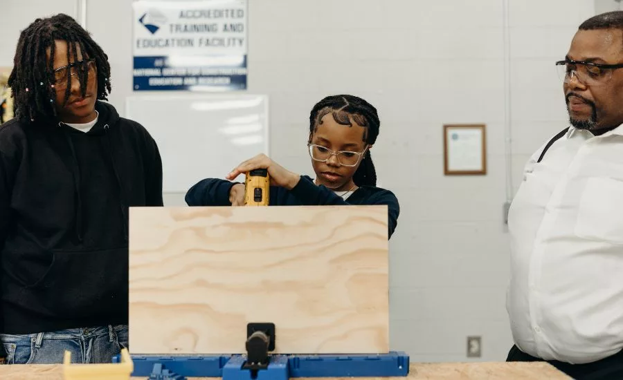 student learning carpentry and using a drill