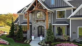 A 2-story home with a stone exterior