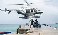Diaster relief picture of a helicopter deliver supplies