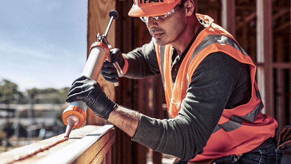 A man applying transparent acrylic flashing