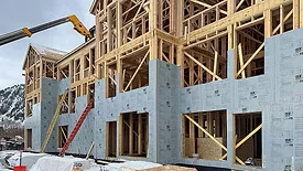 INsulation being added to the wooden frame of a building