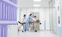 High Performance Gypsum Panels medical professionals moving a patient on a stretcher through the halls of a medical building