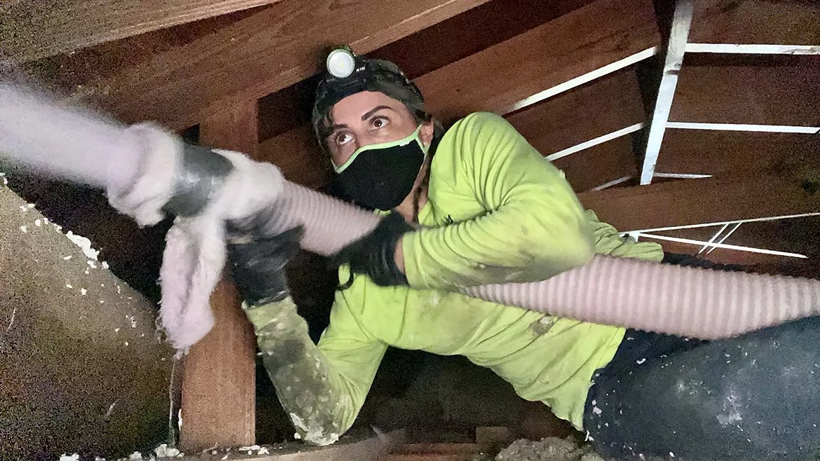 The Attic Queen spraying insulation
