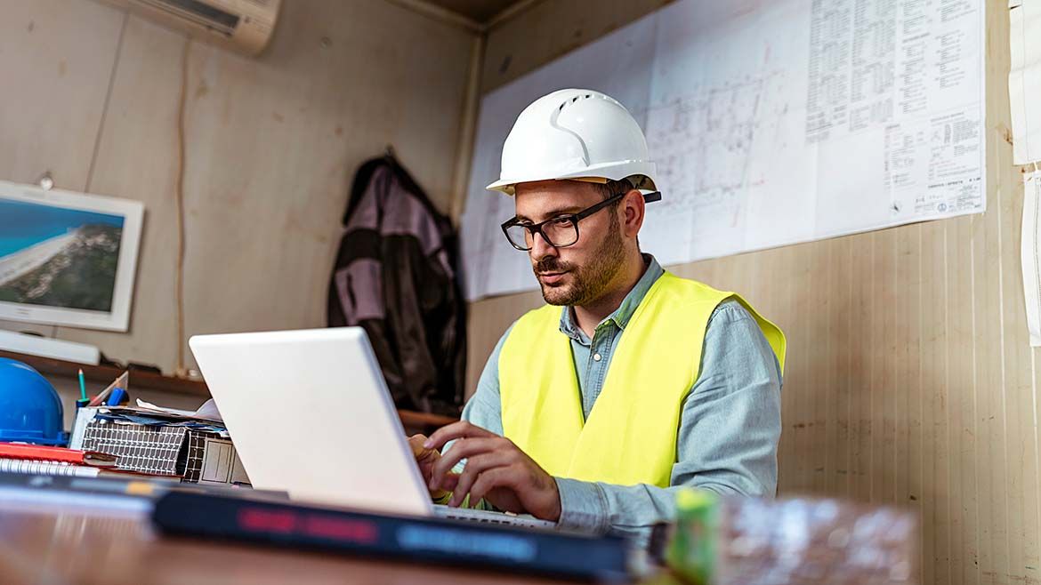 A construction project manager examining a legal document