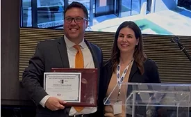 Andrew Irvine, director of product line management for TYPAR, accepts the 2026 Spark Award from Becky Gjerde, Chairman of the LSC Spark Award Committee.