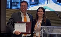 Andrew Irvine, director of product line management for TYPAR, accepts the 2026 Spark Award from Becky Gjerde, Chairman of the LSC Spark Award Committee.