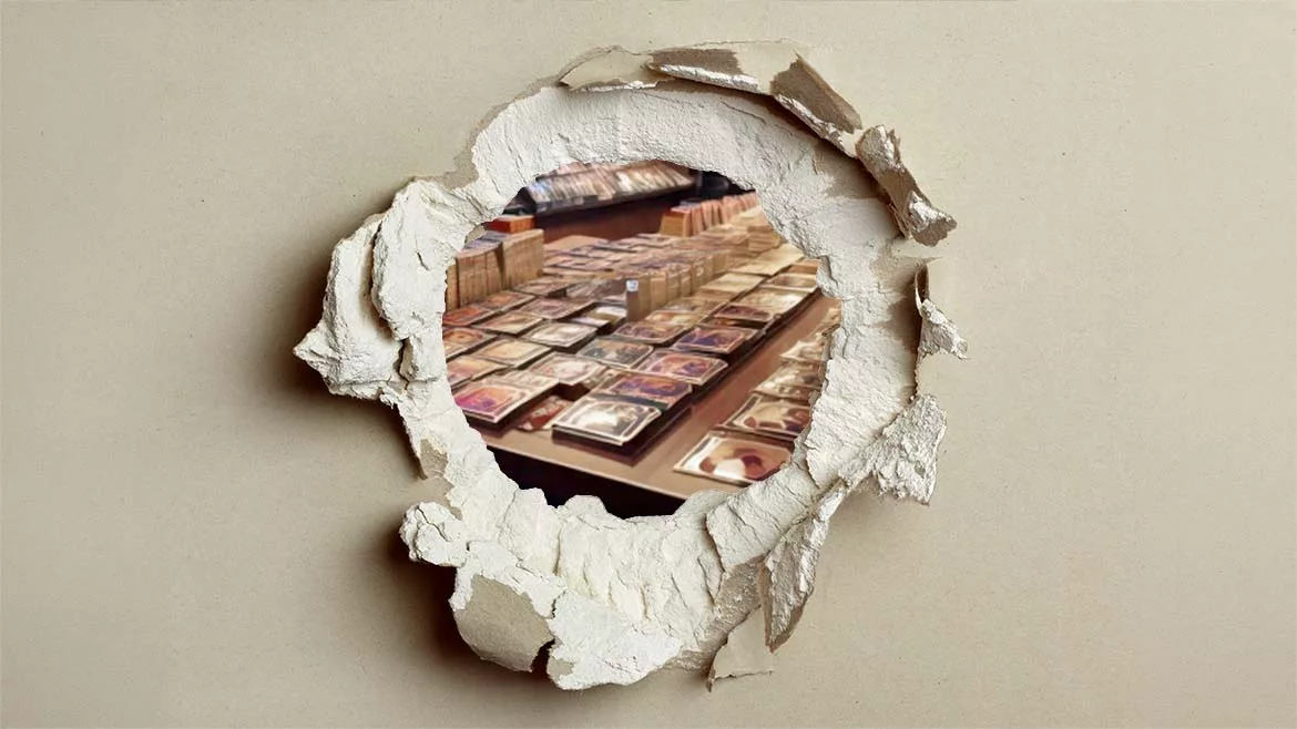 Punctured drywall with Pokemon cards