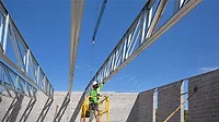 A worker underneath steel framing