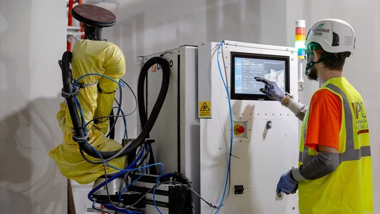 A field technician utilizing the robotic technology of Okibo