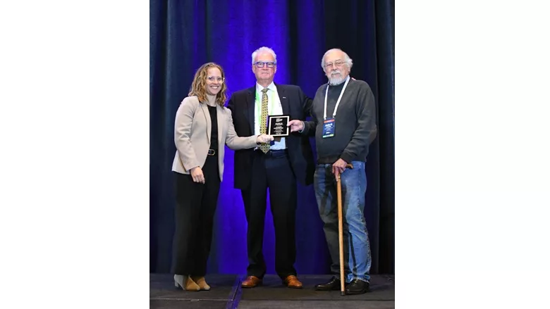 Andre Desjarlais receives Board Recognition award from Board Chair Andrea Wagner Watts, and Laverne Dalgleish of Building Professionals