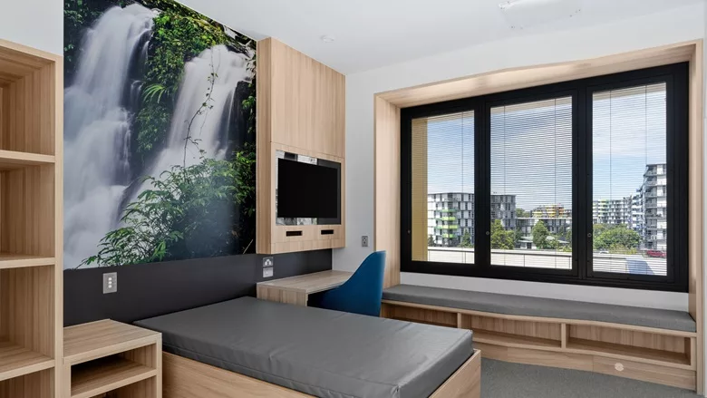 A patient room at the Gold Coast facility in Australia with an artist rendering on the wall from Construction Specialties