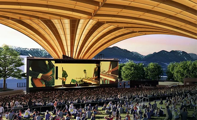 Freedom-Arch-Vancouver Rendering of Vancouver's Freedom Mobile Arch amphitheater showing a large crowd beneath the sweeping mass-timber roof with mountains visible beyond the stage.