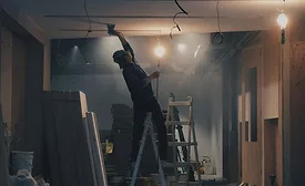 drywall contractor sanding ceiling