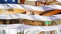 A History of Wall and Ceiling Systems in the U.S. A compilation of interior design images and an American Flag