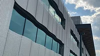 Formed panels with a seamless installation yield pattern uniformity with a unique geometry. A facade made of expanded metal